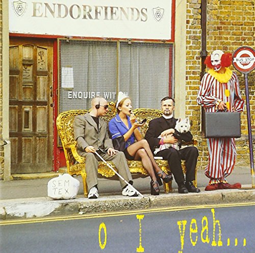 A blind man, a nurse, and a priest sit on a sofa near a clown.