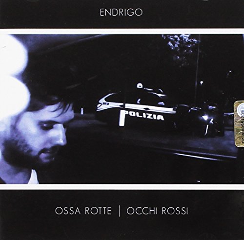 CD cover: man’s profile, distant police cars, dark and moody aesthetic.