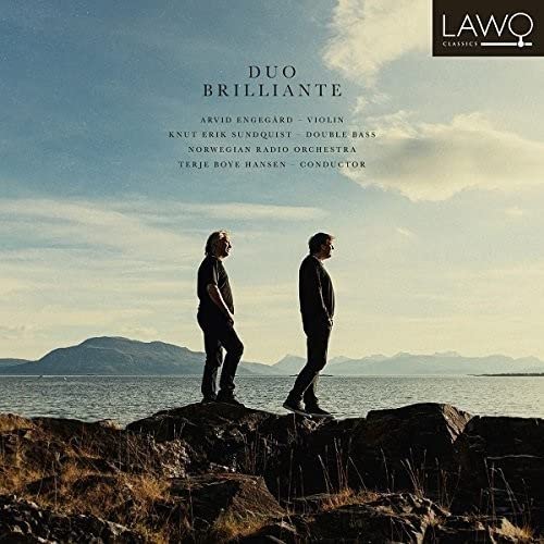 CD cover: two men facing away on a rocky coast, sky background.