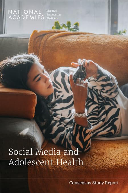 A person in a zebra-print sweater reclines on a couch while using a smartphone.