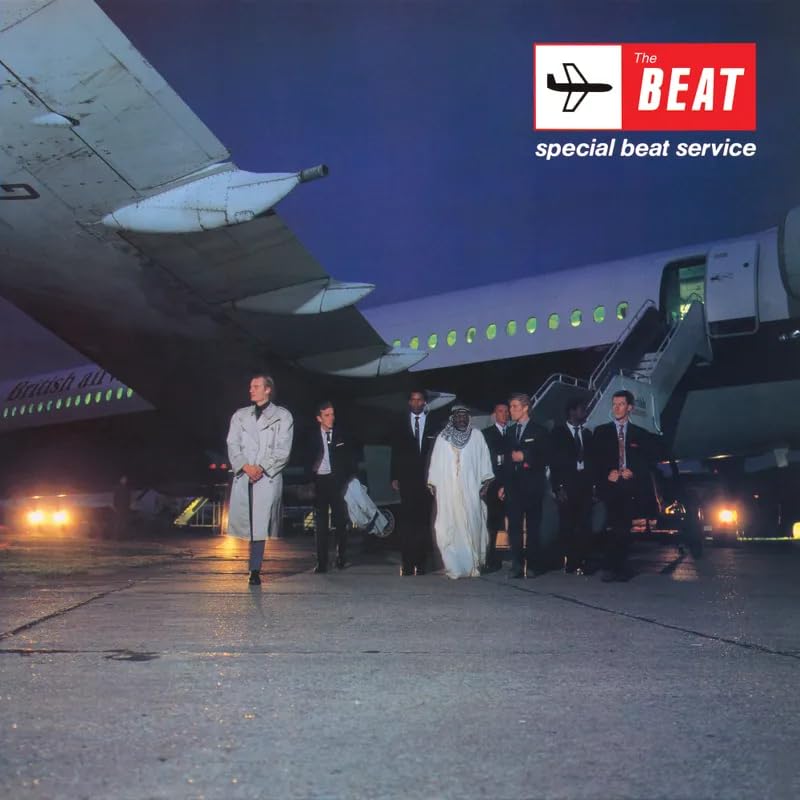 Album cover: airplane with people disembarking, nighttime scene, text “The Beat”.