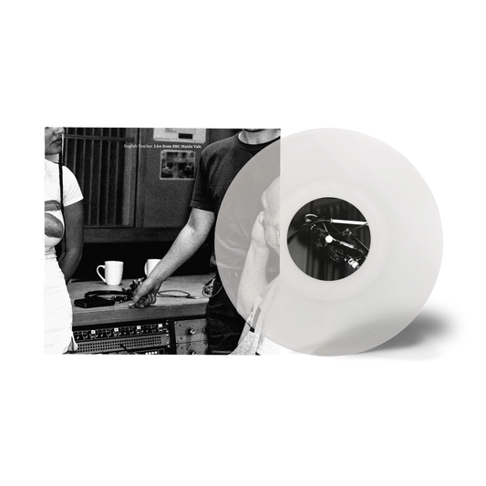 Black and white vinyl record with studio equipment and a musician.