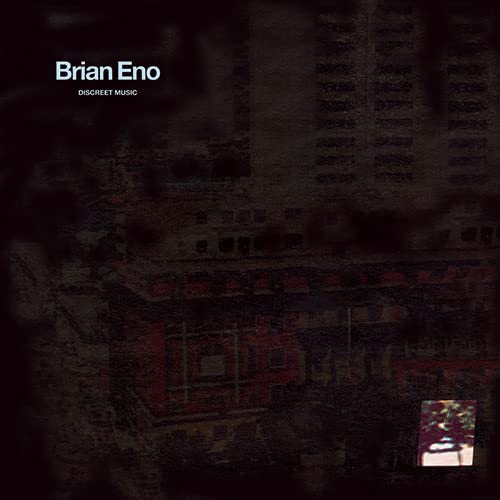 Brian Eno's "Discreet Music" vinyl album cover with blurred building image.