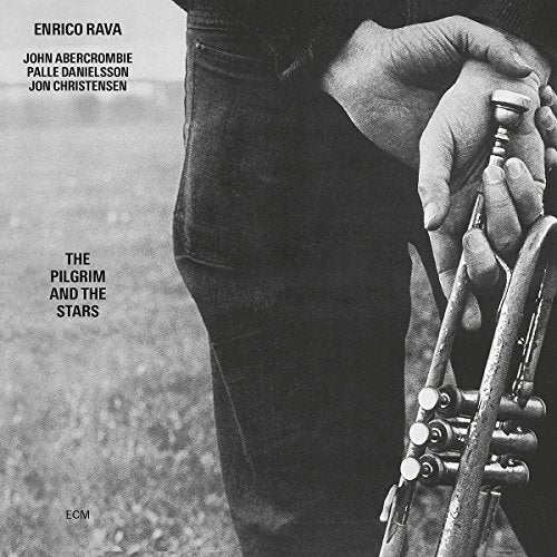 Black and white album cover featuring hands holding a trumpet.