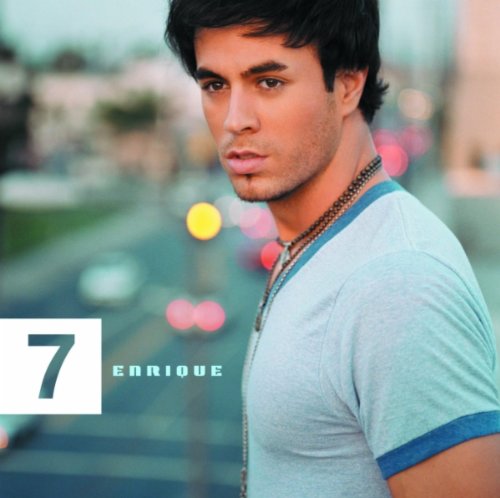 Enrique Iglesias album cover, "7", with artist portrait and blurred city lights.