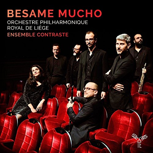 Ensemble in black attire seated in red theater chairs on "Besame Mucho" CD cover.