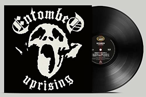 Entombed album cover with skull and mushroom graphic next to a vinyl record.