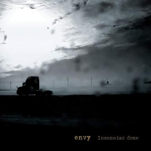 CD cover: dark, atmospheric landscape with a truck and stormy sky.