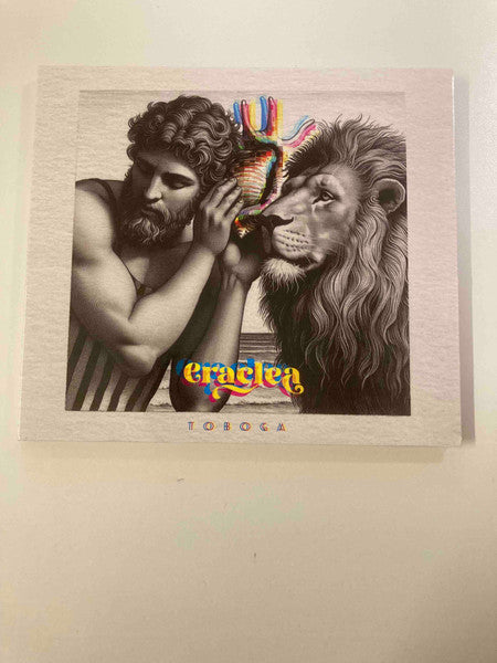 CD cover: man, lion, and colorful shell against a pink background.