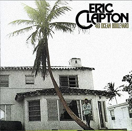 Album cover featuring Eric Clapton standing before a house with a tall palm tree.
