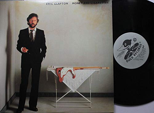 Eric Clapton album cover with a man in a suit and a guitar.