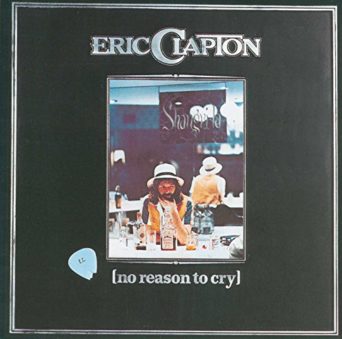 Album cover showing Eric Clapton wearing a hat at a table with drinks.