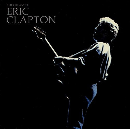 Eric Clapton playing a guitar, album cover with dark background.
