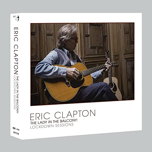 Eric Clapton album cover: man with guitar against a wooden door.
