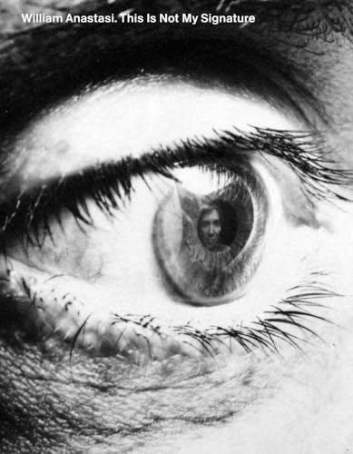 Close-up of an eye reflecting a portrait of a man.