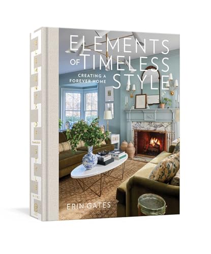Hardcover book titled Elements of Timeless Style featuring a cozy blue living room interior.