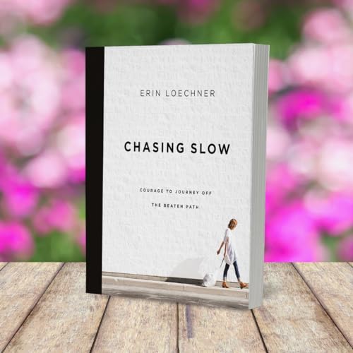 Book cover with white textured background and pink floral blur.