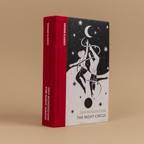 A book with a red spine and a black and white cover featuring acrobats.