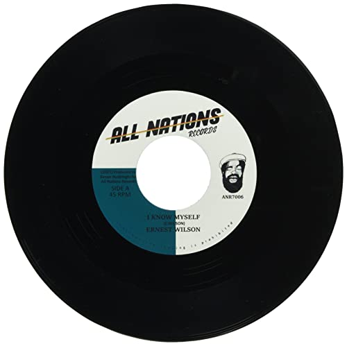 Black vinyl record with a yellow and blue label, featuring a portrait.
