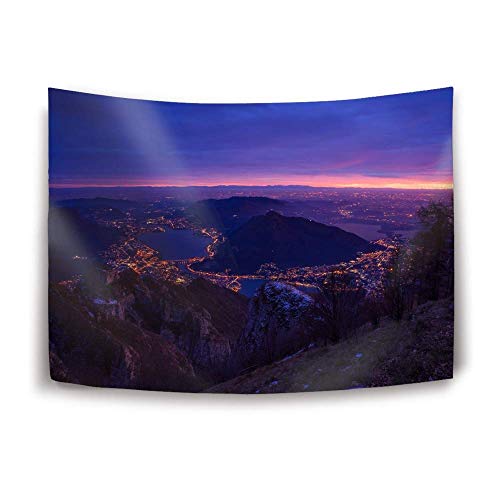 "Tapestry featuring a cityscape at dusk with mountains and a purple sky."