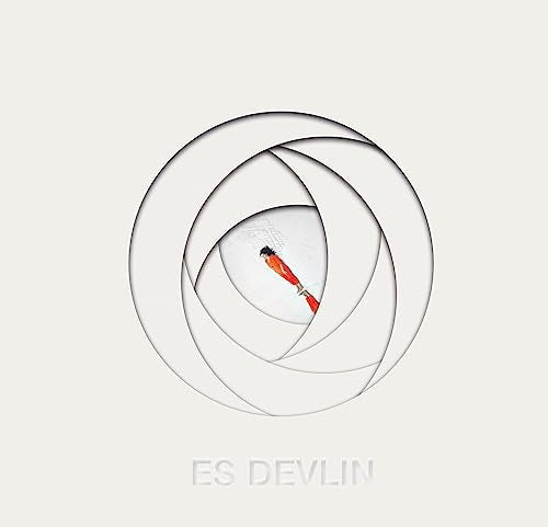 White layered circles framing a diver in a red suit, text “ES DEVLIN”.