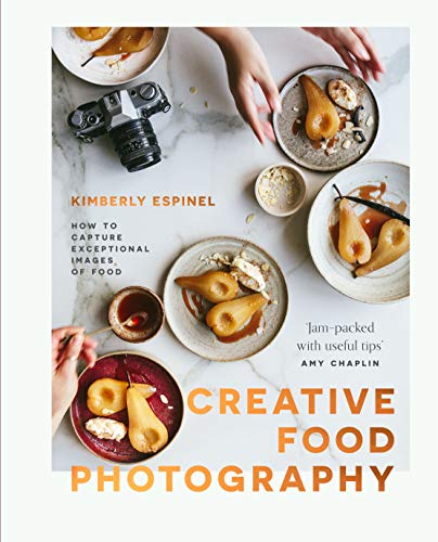 Book cover with pears, camera, and hands arranging food on plates.