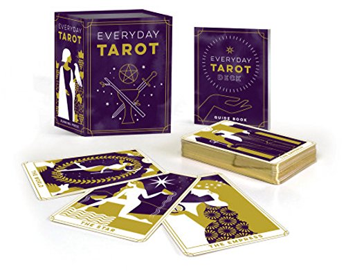 Mini tarot deck and guidebook with gold foil accents on dark purple.