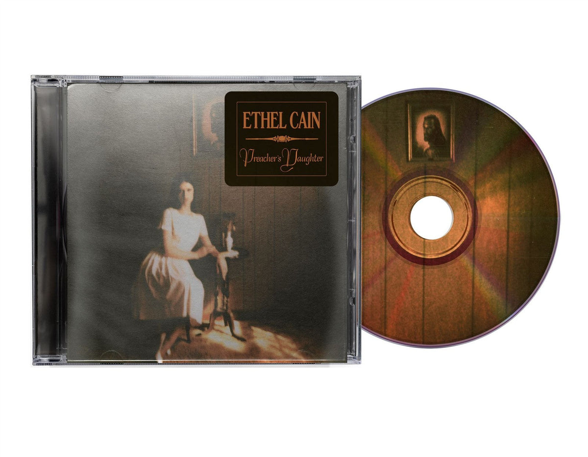 Ethel Cain’s “Preacher’s Daughter” CD case and disc with a portrait.