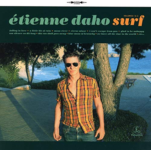 "CD cover featuring a man standing by a tree near water."