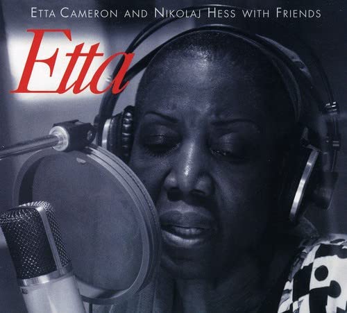 CD cover featuring Etta Cameron with headphones and a microphone.