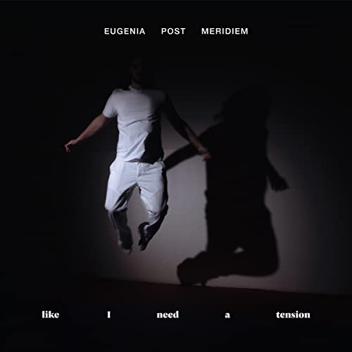 Album cover: man mid-jump in white clothing against a dark background.