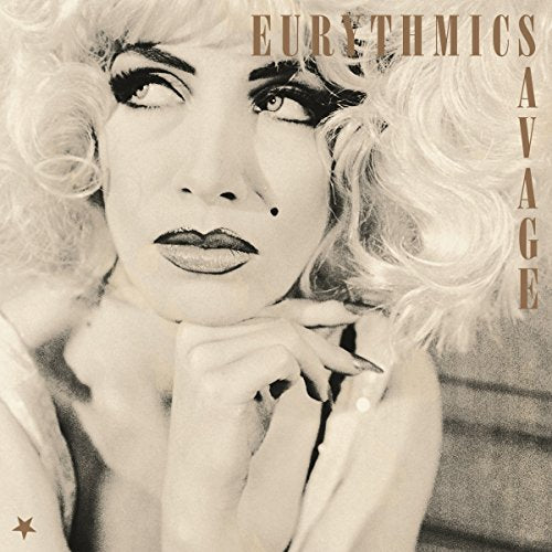 Close-up of Annie Lennox with dramatic makeup on the "Savage" vinyl album cover.