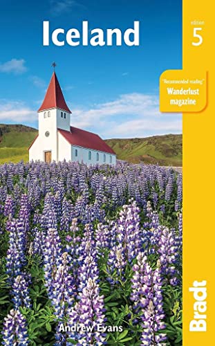 Iceland travel guide cover with a church, lupines, and mountains.