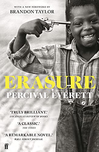 Black and white book cover showing a smiling boy holding a gun to his head.