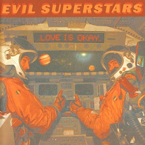"Album cover art featuring two astronauts in a spaceship with 'Love Is Okay' displayed."
