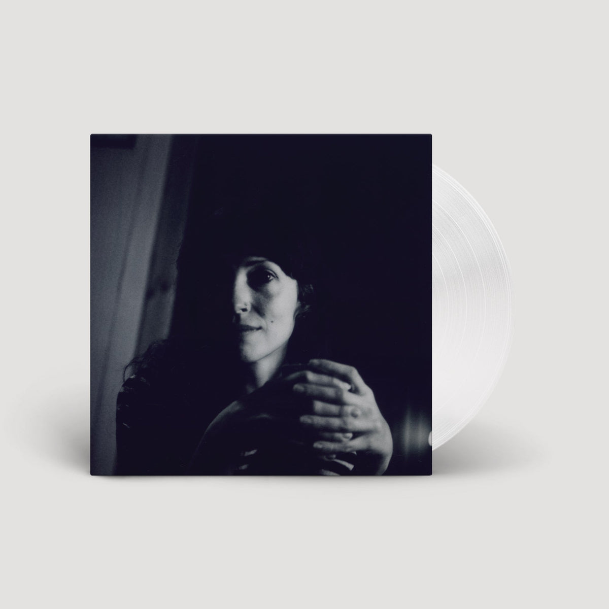 Vinyl record with album cover featuring a shadowed portrait of a woman.