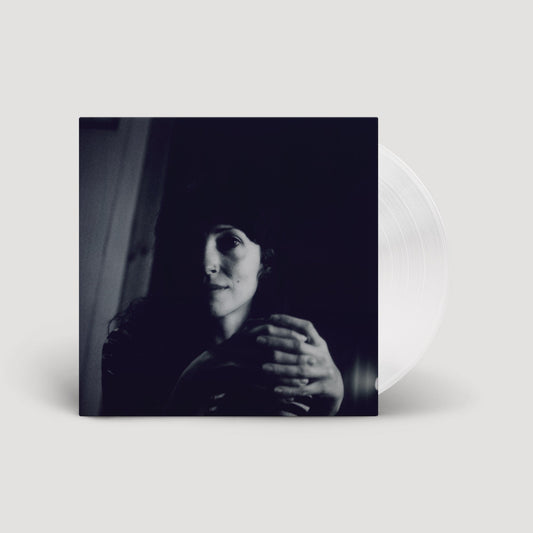 Vinyl record with album cover featuring a shadowed portrait of a woman.