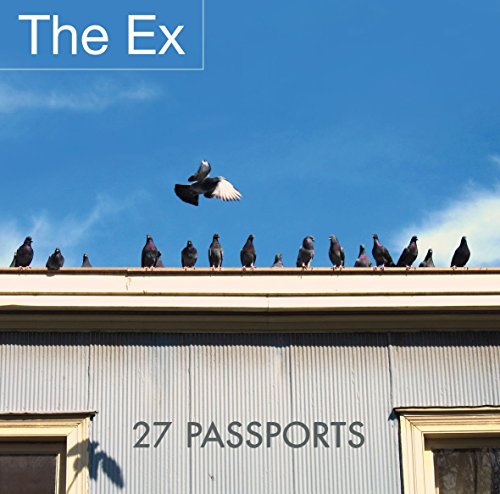Album cover featuring pigeons on a roof with one flying, against a blue sky.