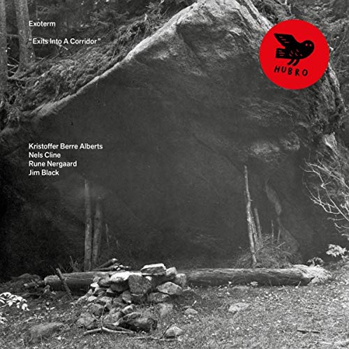 Black and white album cover with a large rock and red bird logo.