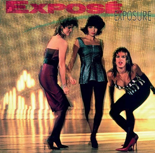 "Album cover featuring three women in outfits, posing in front of a lit stage."