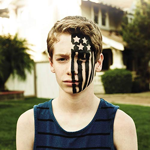 A young person with black American flag face paint on one side of their face.