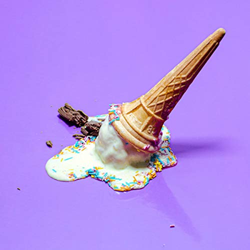 Melted ice cream cone with sprinkles on a purple background.