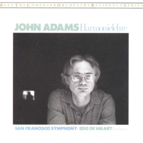 CD cover featuring a portrait of composer John Adams wearing glasses.