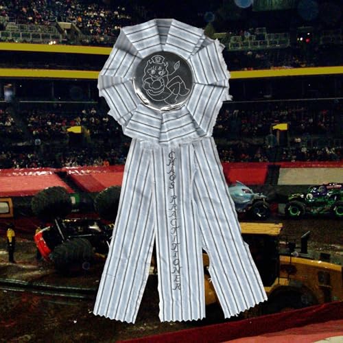 Large rosette ribbon with central illustration, stadium and monster trucks blurred behind.
