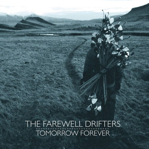 A vinyl record cover featuring a person holding flowers in a field.