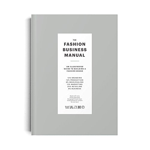 The image shows a book titled "The Fashion Business Manual" on a gray background. Alt text: A gray book cover with white rectangle and black text "The Fashion Business Manual".