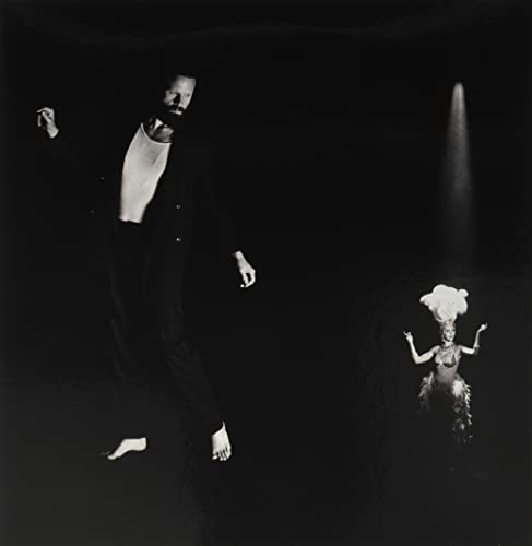 Black and white album cover featuring a man and a dancer in performance.