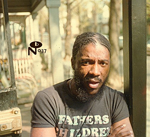 CD cover featuring a portrait of a Black man with braids and beard.