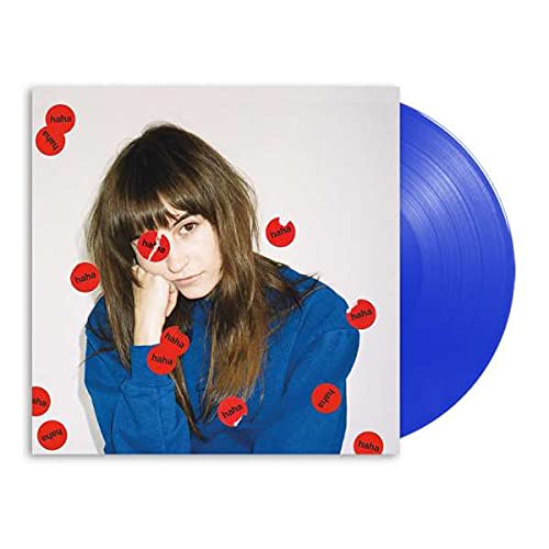 Vinyl record with album cover featuring a woman and red circles, blue disc.