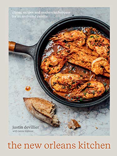 Cookbook cover featuring shrimp in a cast iron skillet with bread.